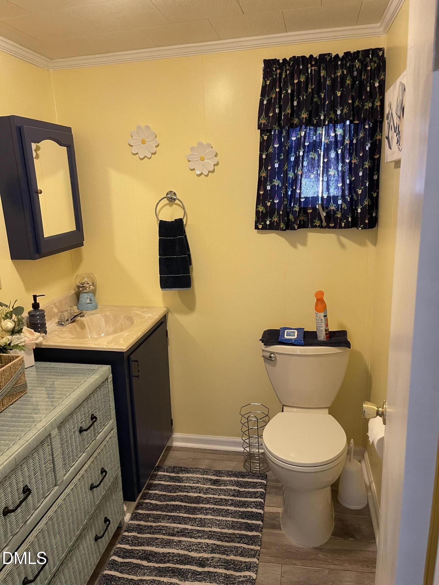 129 Boulder Boulevard Manson, NC 27553 - Photo 25 of 43 a bathroom with a toilet a sink and mirror
