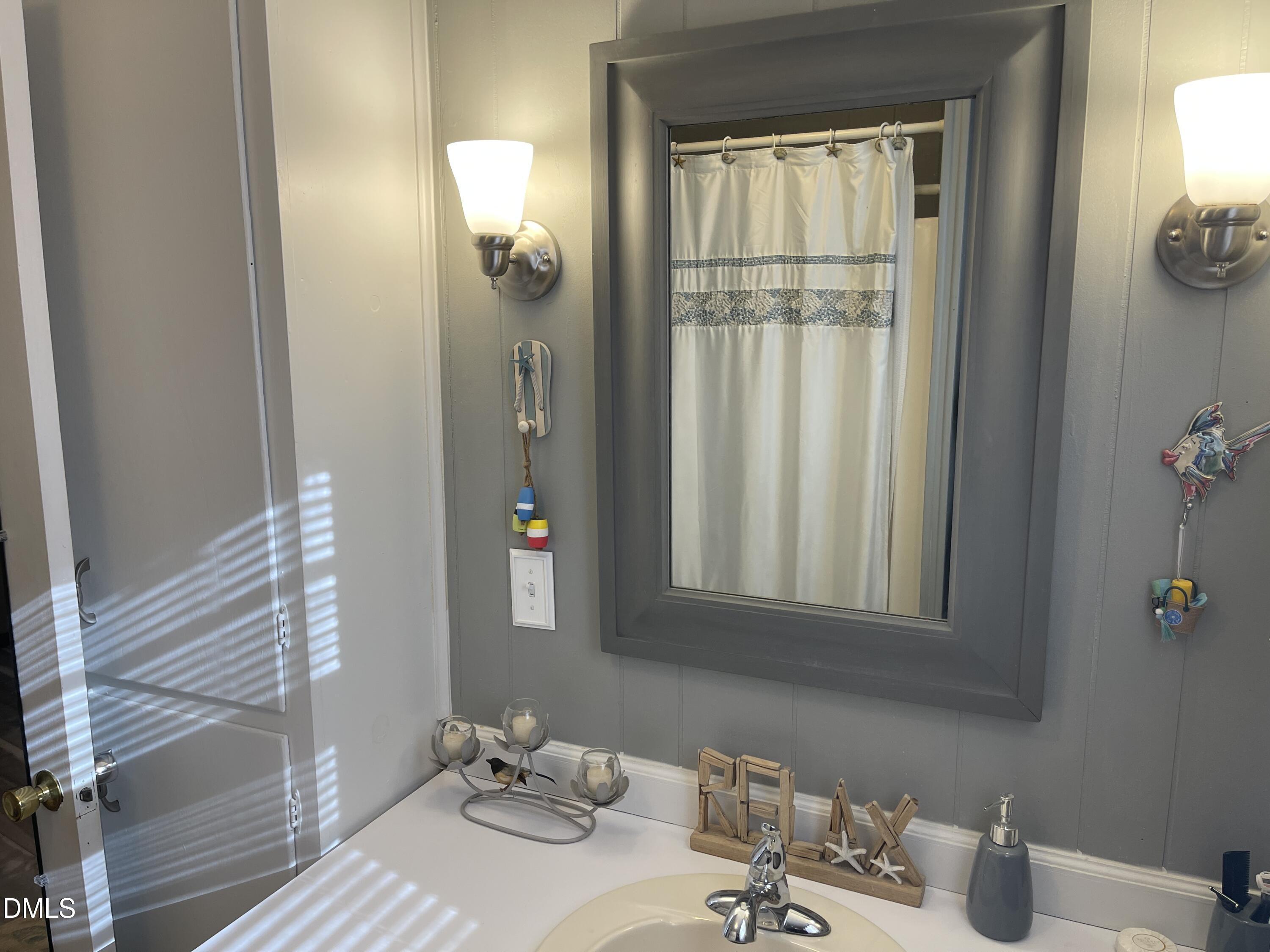 129 Boulder Boulevard Manson, NC 27553 - Photo 28 of 43 a bathroom with a sink and a mirror