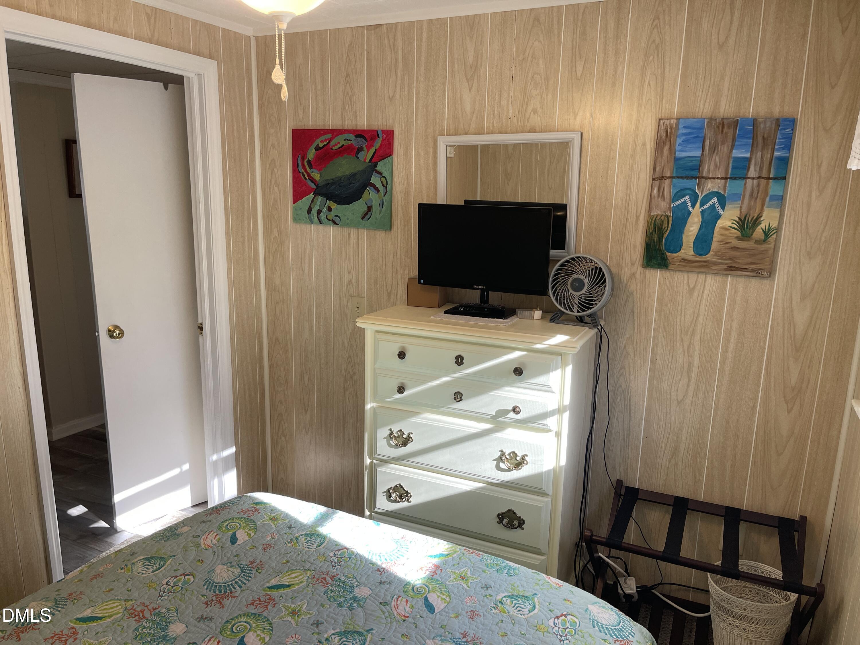 129 Boulder Boulevard Manson, NC 27553 - Photo 32 of 43 a bedroom with a bed and a flat screen tv