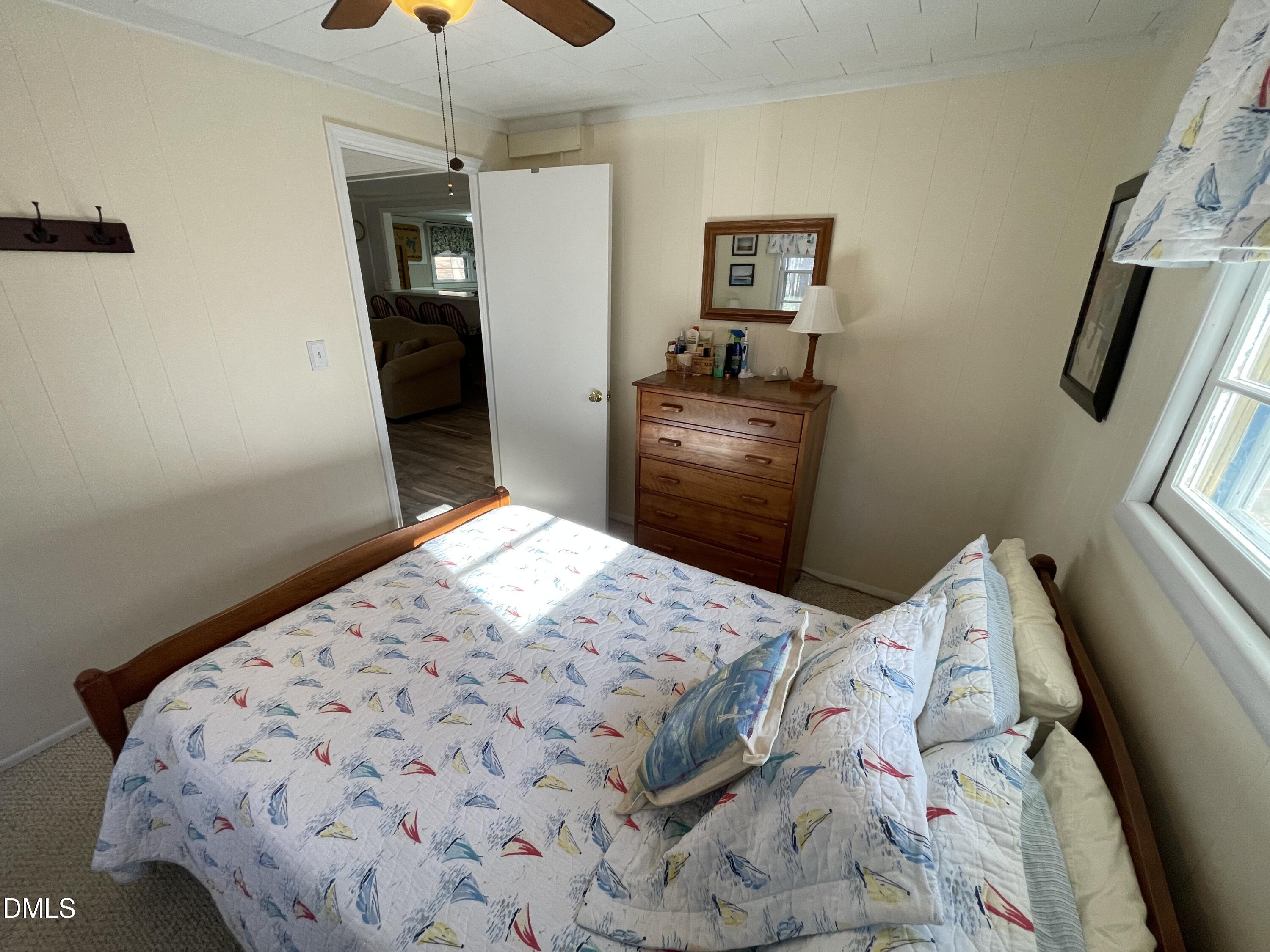 129 Boulder Boulevard Manson, NC 27553 - Photo 34 of 43 a bedroom with a bed and a chandelier