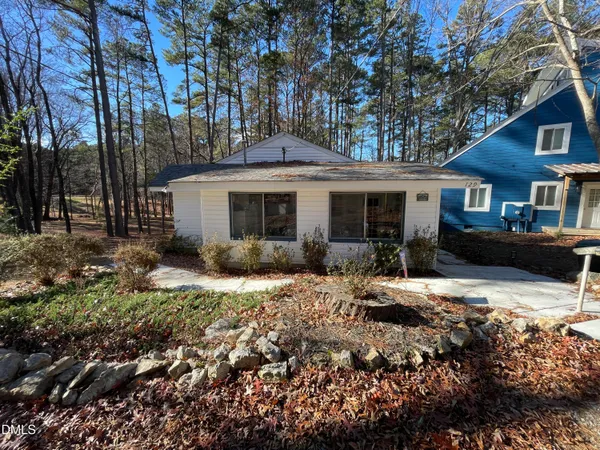 a view of a house with a yard covered in snow