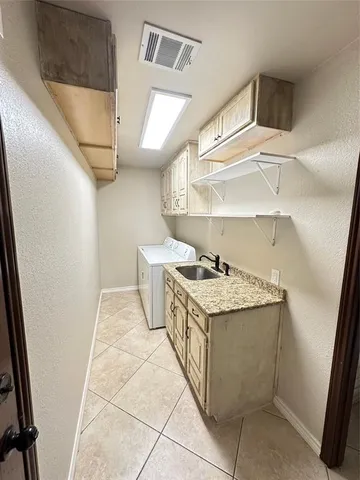 an empty room with wooden floor fireplace and windows