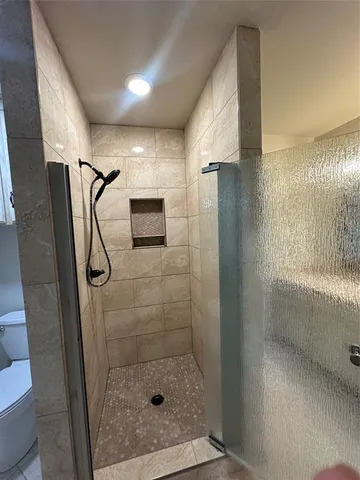 a view of a balcony with wooden floor and iron fence