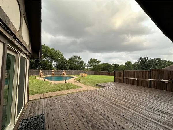 a view of a swimming pool with a yard