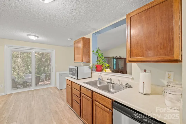 a kitchen with sink cabinets and wooden floor