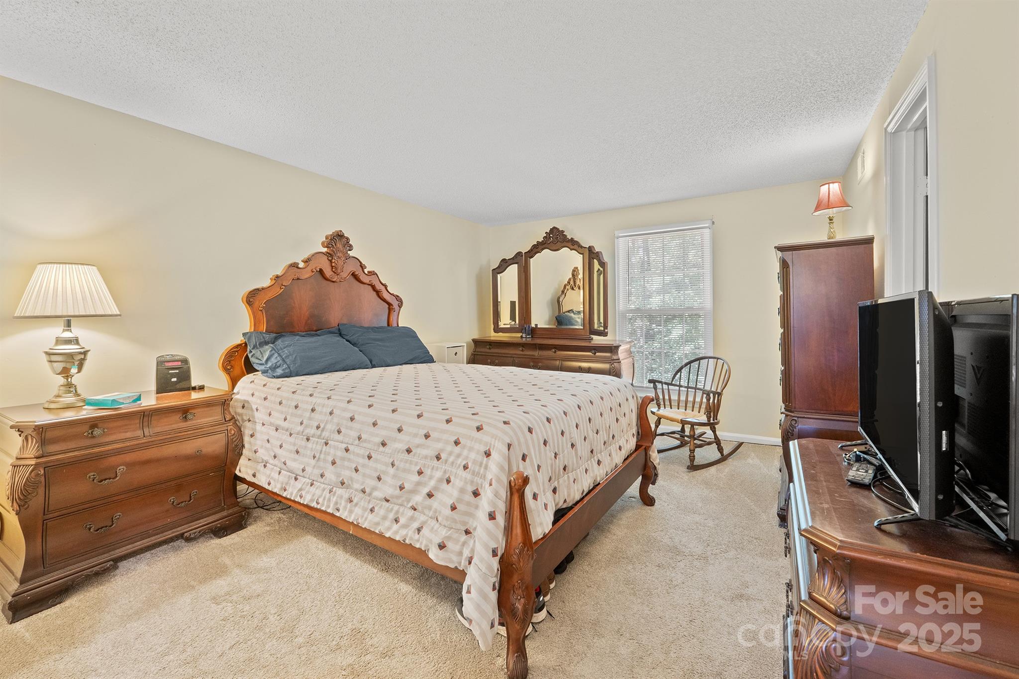 6836 Shiloh Ridge Lane Charlotte, NC 28212 - Photo 16 of 25 a bedroom with a bed and a flat tv screen on dresser