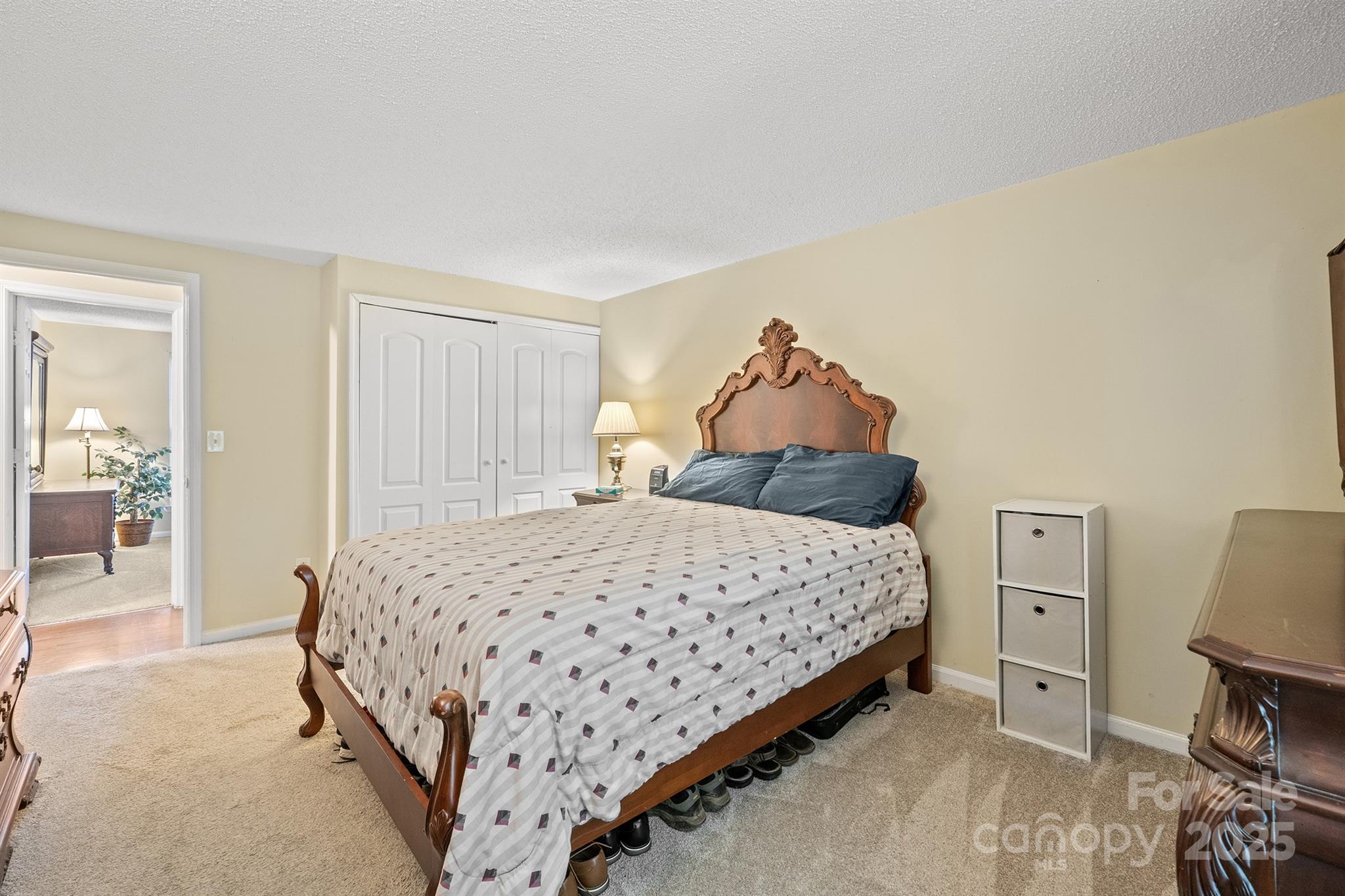 6836 Shiloh Ridge Lane Charlotte, NC 28212 - Photo 17 of 25 a bedroom with a bed and a chair in it