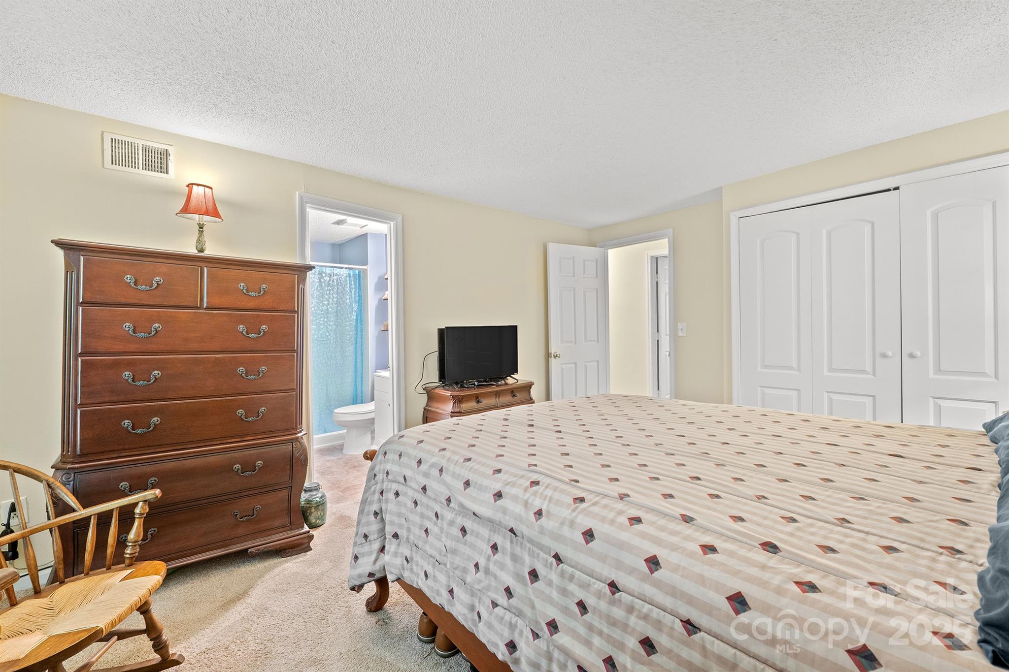 6836 Shiloh Ridge Lane Charlotte, NC 28212 - Photo 18 of 25 a bedroom with a bed and a dresser