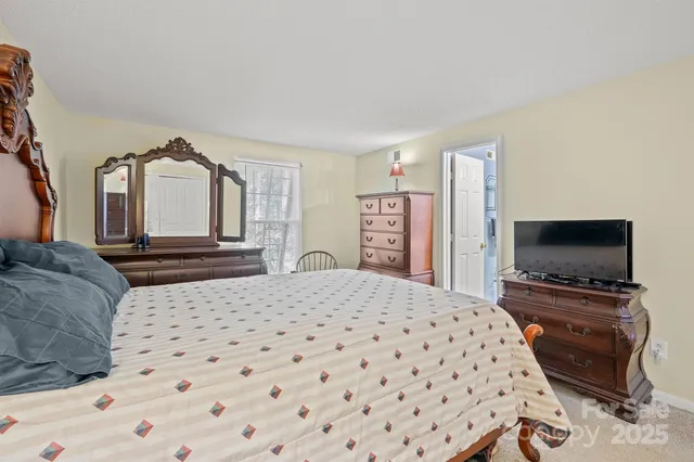 a living room with a bed and a flat screen tv