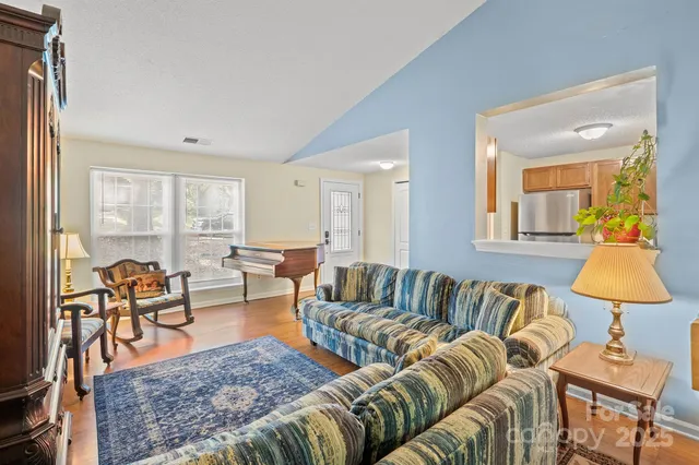 a living room with furniture and a lamp