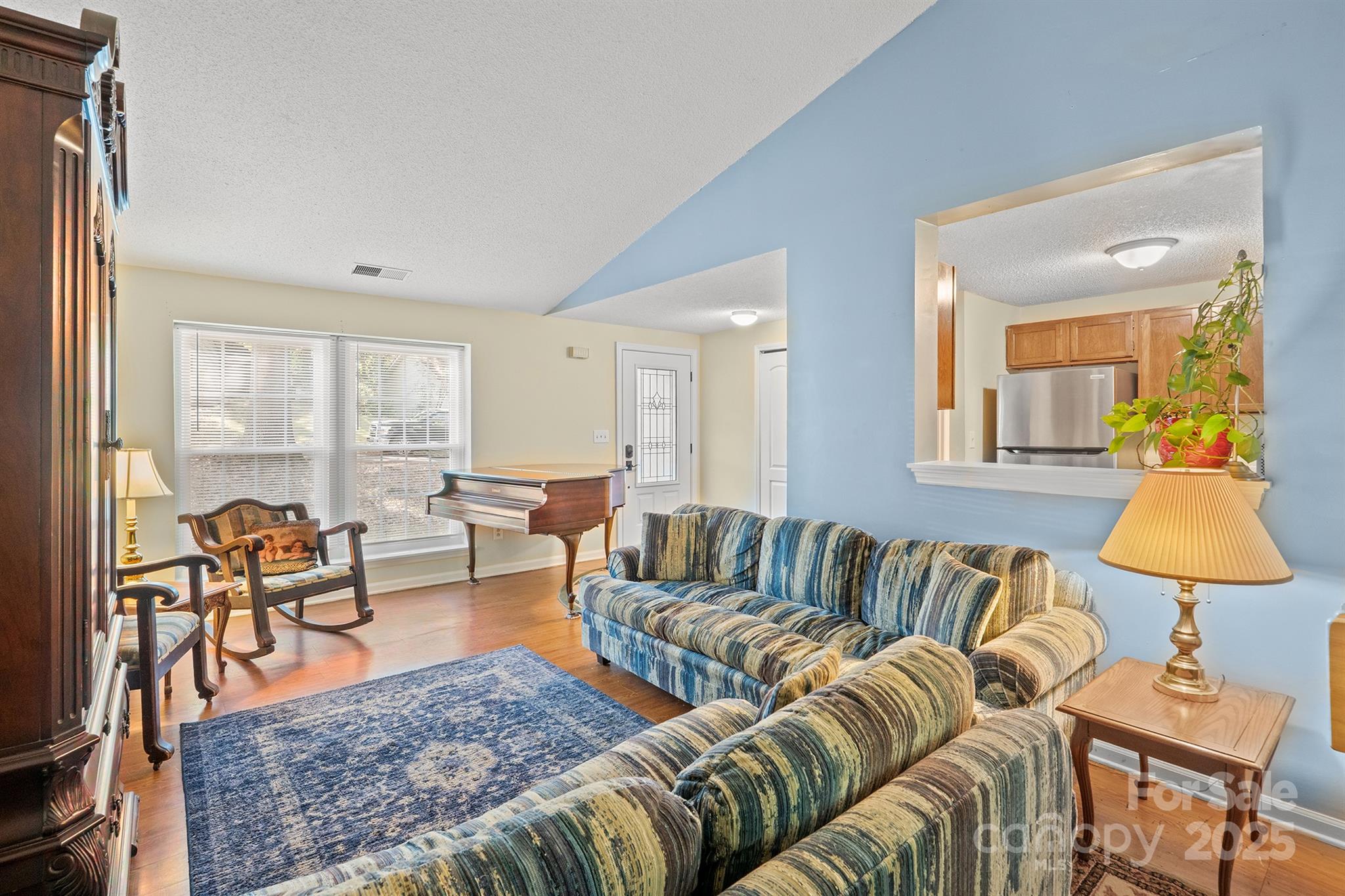 6836 Shiloh Ridge Lane Charlotte, NC 28212 - Photo 5 of 25 a living room with furniture and a lamp