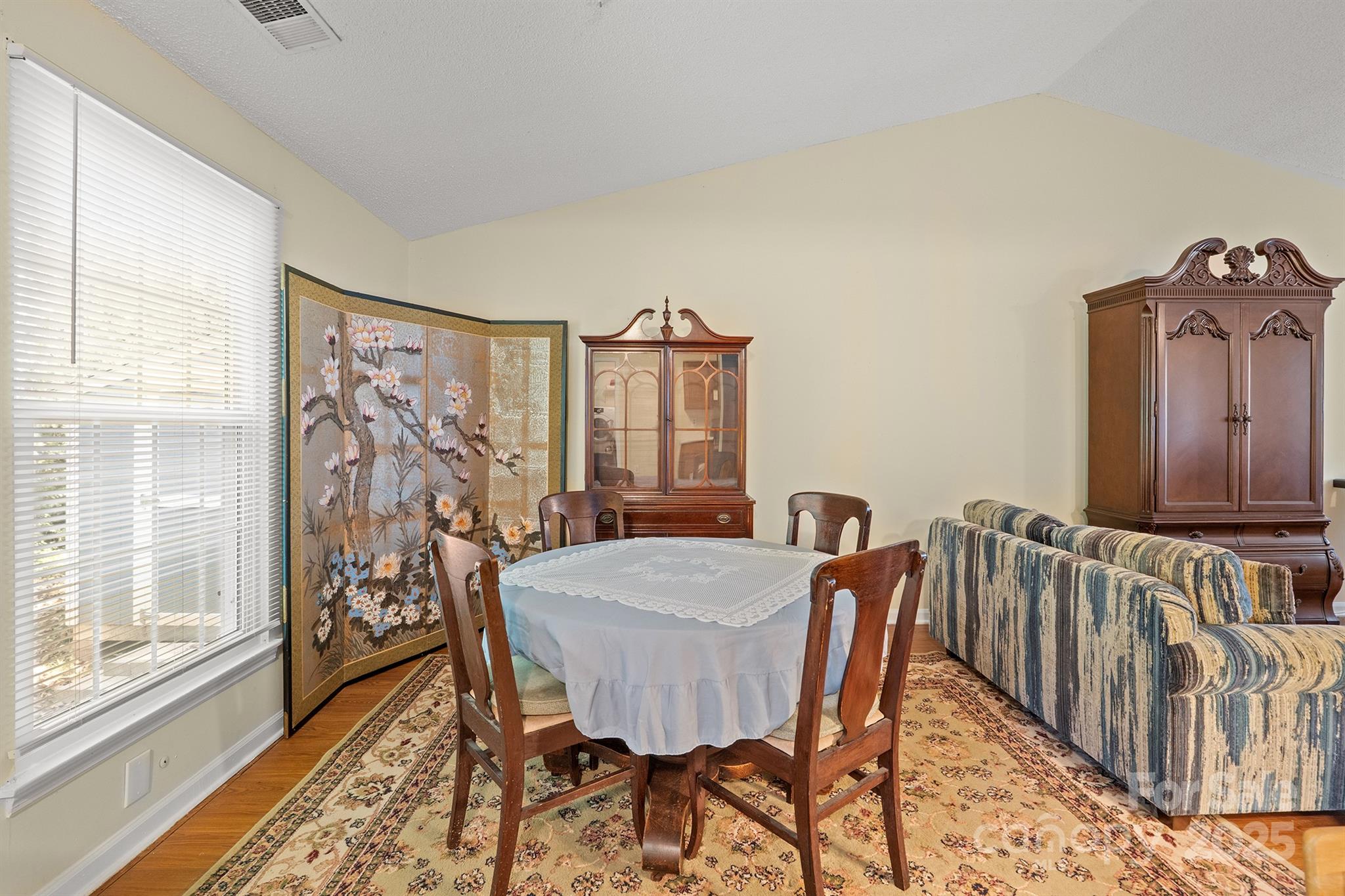 6836 Shiloh Ridge Lane Charlotte, NC 28212 - Photo 7 of 25 a view of a dining room with furniture window and wooden floor