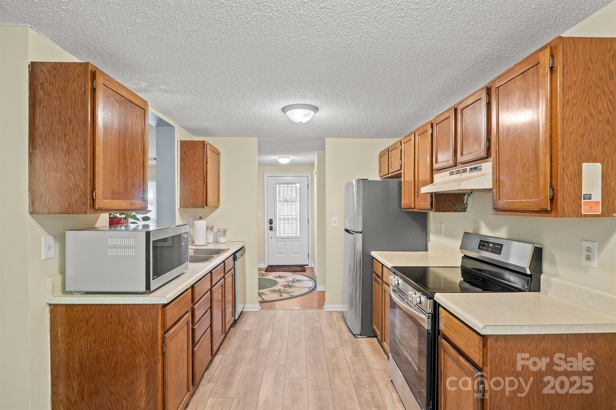 6836 Shiloh Ridge Lane Charlotte, NC 28212 - Photo 10 of 25 a kitchen with stainless steel appliances granite countertop a stove a sink a refrigerator and a cabinets