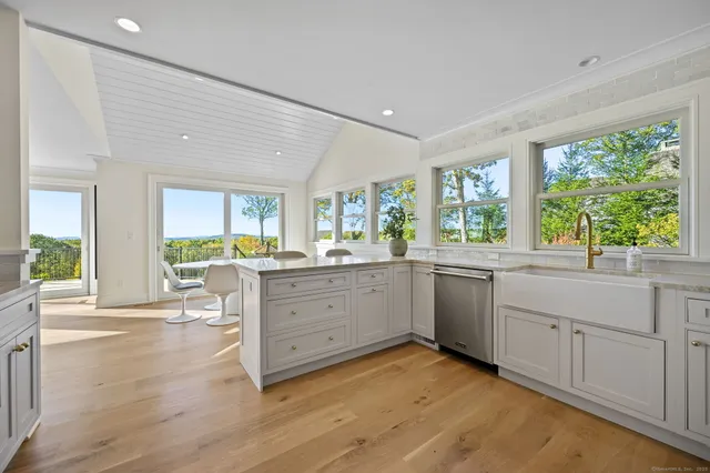a kitchen with sink cabinets and wooden floor