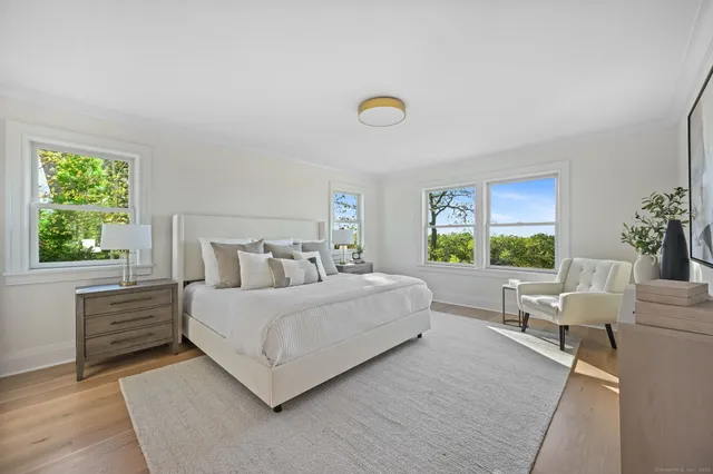 a bedroom with a large bed and a couch