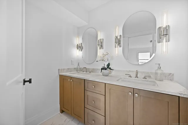 a bathroom with a double vanity sink and a mirror