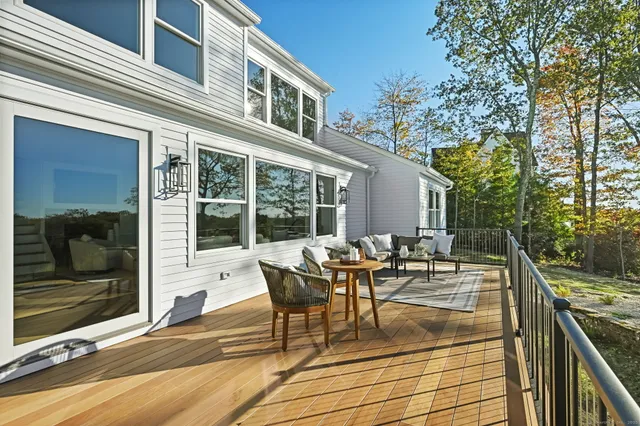 a view of a patio with couches table and chairs and potted plants