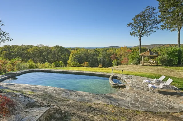 a view of a swimming pool with a yard