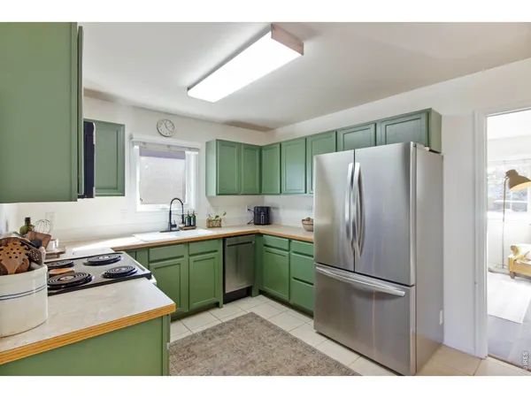 a kitchen with a refrigerator sink and stove