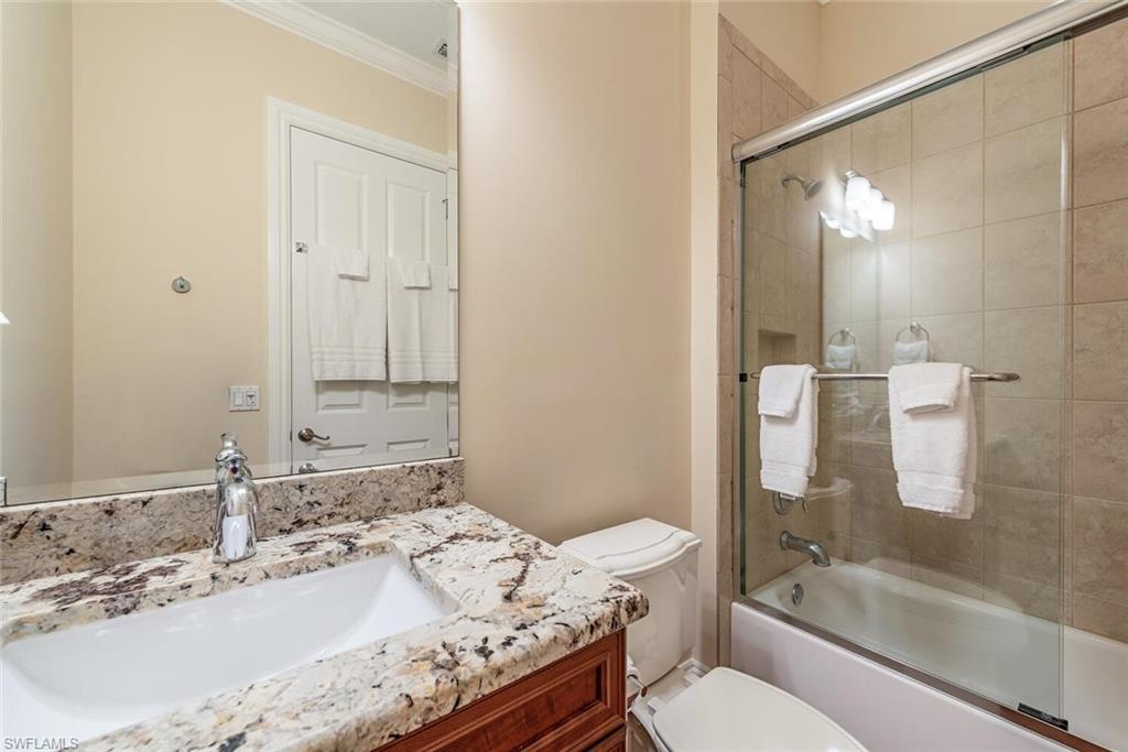 7599 Moorgate Point Way Naples, FL 34113 - Photo 11 of 24 a bathroom with a granite countertop sink toilet and shower