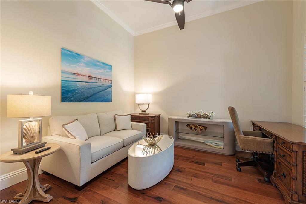 7599 Moorgate Point Way Naples, FL 34113 - Photo 12 of 24 a living room with furniture and a wooden floor
