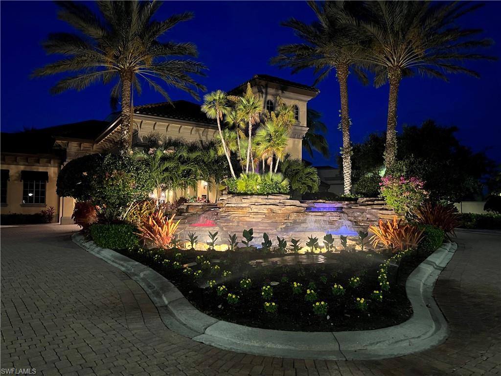 7599 Moorgate Point Way Naples, FL 34113 - Photo 20 of 24 a view of a house with a yard potted plants