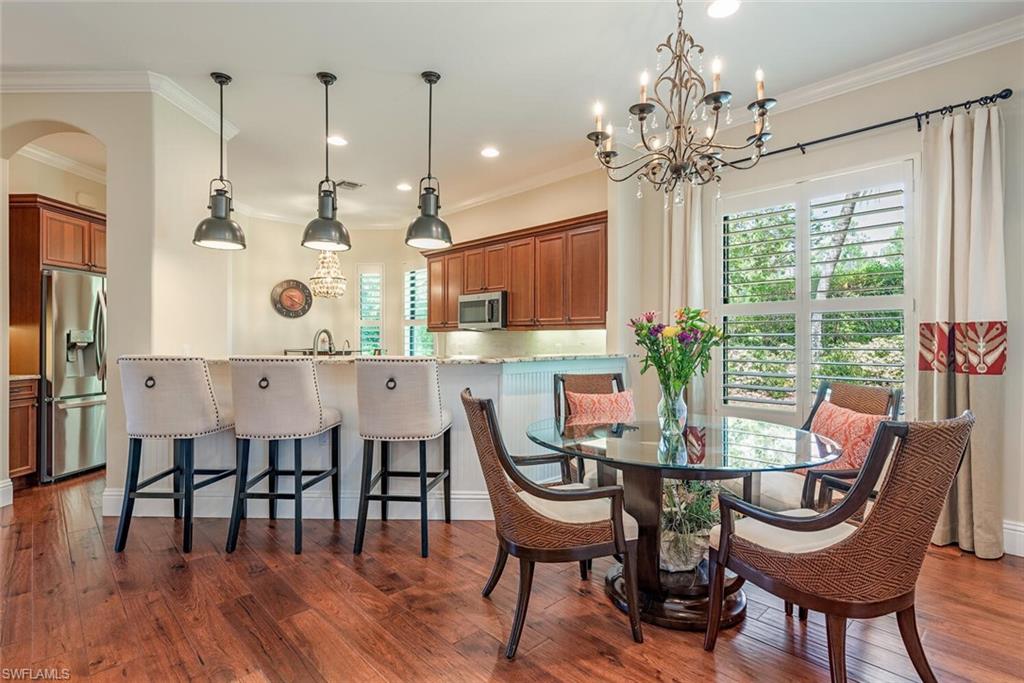 7599 Moorgate Point Way Naples, FL 34113 - Photo 4 of 24 a view of a dining room with furniture window and wooden floor