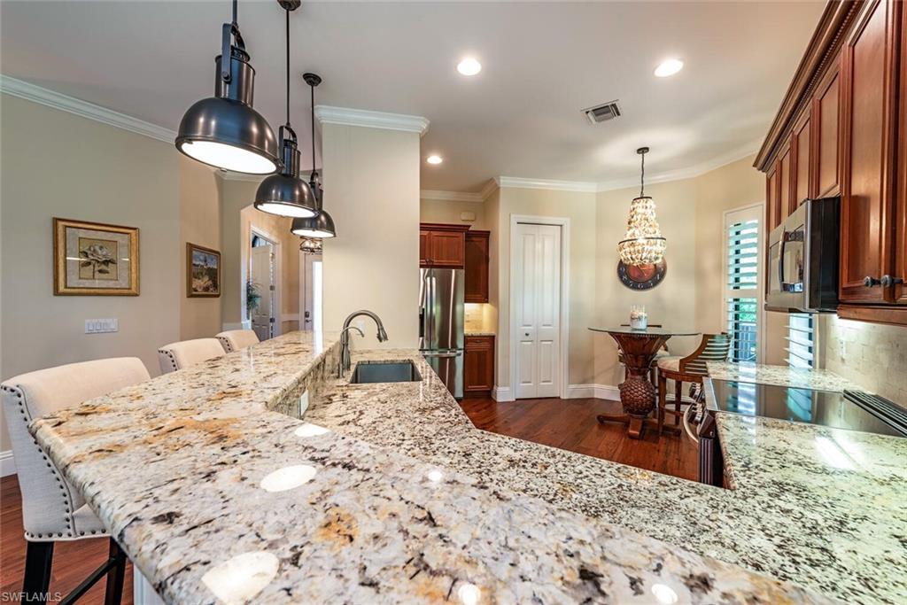 7599 Moorgate Point Way Naples, FL 34113 - Photo 6 of 24 a view of a dining room and livingroom