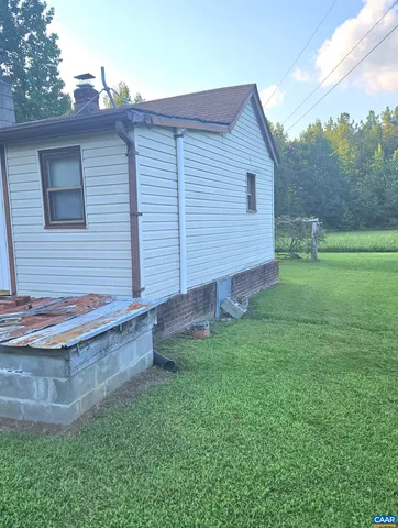 a view of a backyard with wooden fence