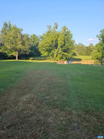 a view of a field with an trees