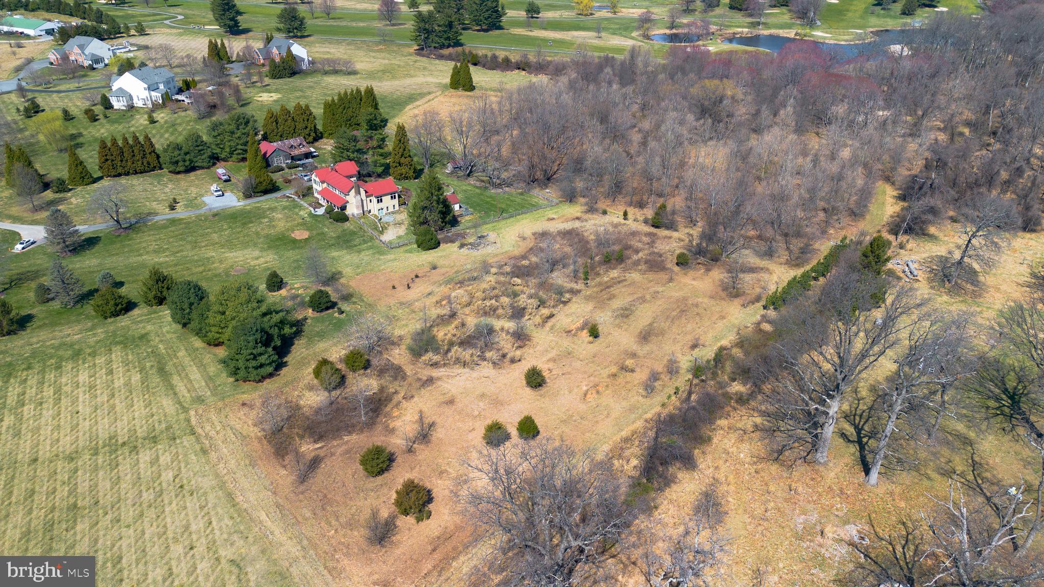 6001 Riggs Road Laytonsville, MD 20882 - Photo 9 of 12 a backyard of a house with a yard and outdoor seating