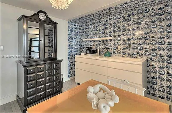 a dining room with a wooden table and chairs