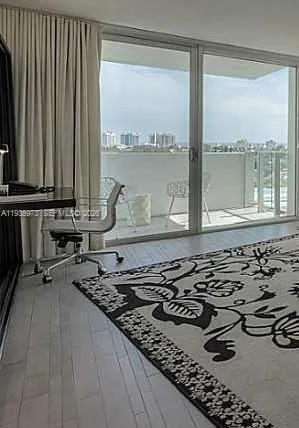 a bedroom with bed and a large window