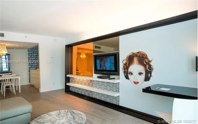 a view of patio with table and chairs plants and large tree