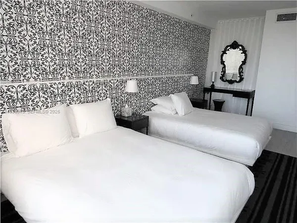 a bedroom with a bed and a chair