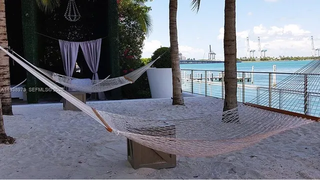 a view of a chairs and table in backyard