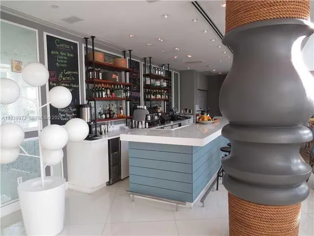 a lobby with furniture and potted plants