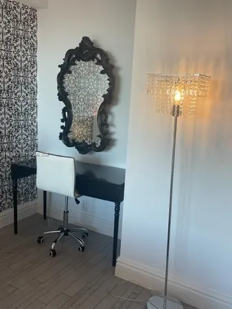 a living room with couches and a chandelier