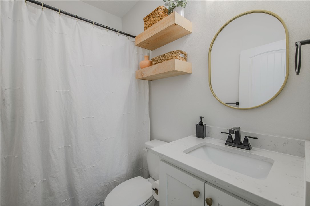 3332 Hunters Crossing Bryan, TX 77808 - Photo 11 of 26 a bathroom with a sink and a mirror