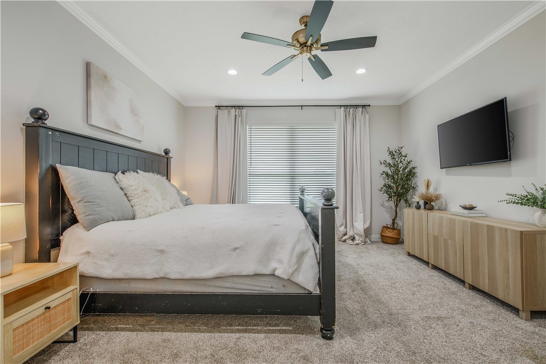 3332 Hunters Crossing Bryan, TX 77808 - Photo 13 of 26 a spacious bedroom with a bed and a flat screen tv