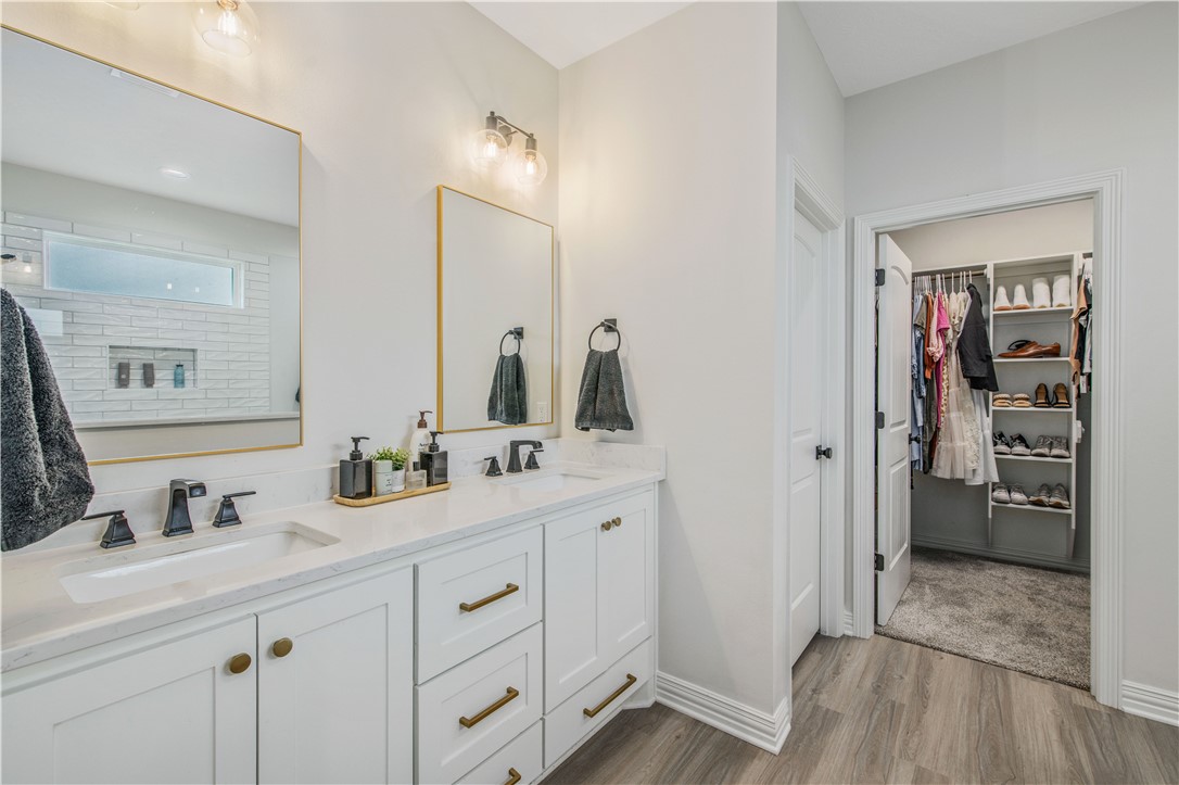 3332 Hunters Crossing Bryan, TX 77808 - Photo 14 of 26 a bathroom with a double vanity sink and mirror
