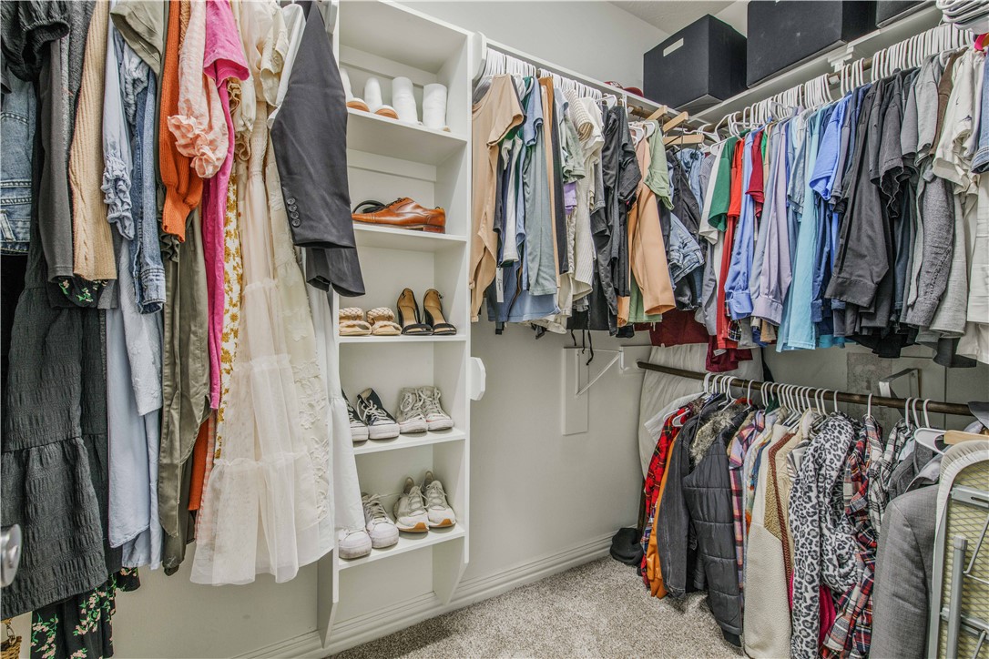 3332 Hunters Crossing Bryan, TX 77808 - Photo 16 of 26 a view of walk in closet with clothes and shoes