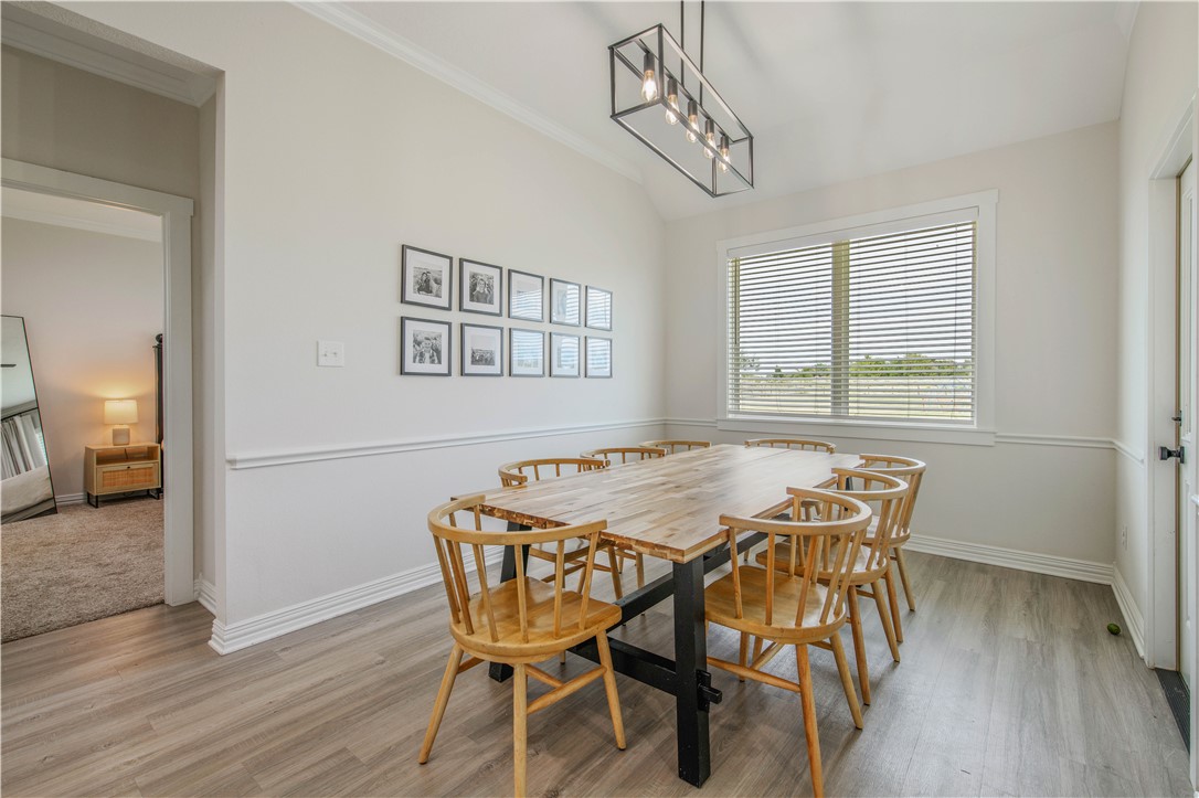 3332 Hunters Crossing Bryan, TX 77808 - Photo 21 of 26 a view of a dining room with furniture and wooden floor