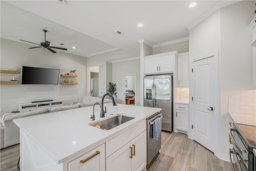 3332 Hunters Crossing Bryan, TX 77808 - Photo 22 of 26 a kitchen with a sink appliances and cabinets