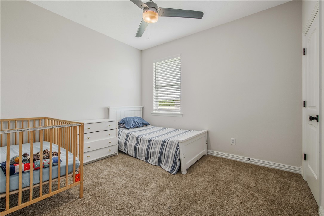 3332 Hunters Crossing Bryan, TX 77808 - Photo 7 of 26 a bedroom with a bed and window