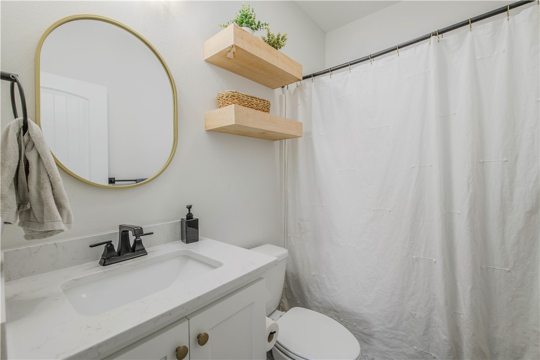 3332 Hunters Crossing Bryan, TX 77808 - Photo 8 of 26 a bathroom with a sink and a mirror