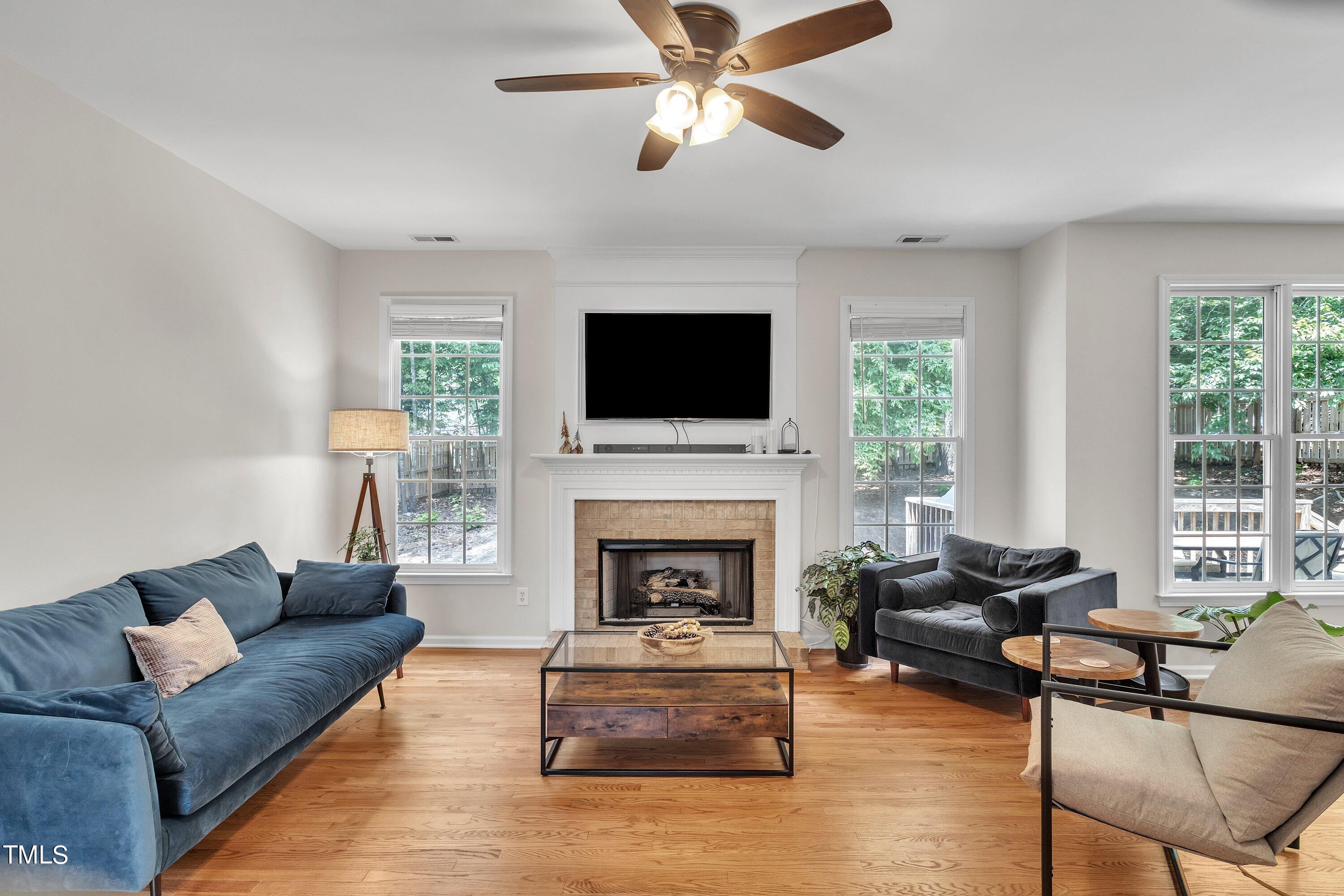 4702 Regency Drive Durham, NC 27713 - Photo 11 of 45 a living room with furniture a fireplace and a flat screen tv