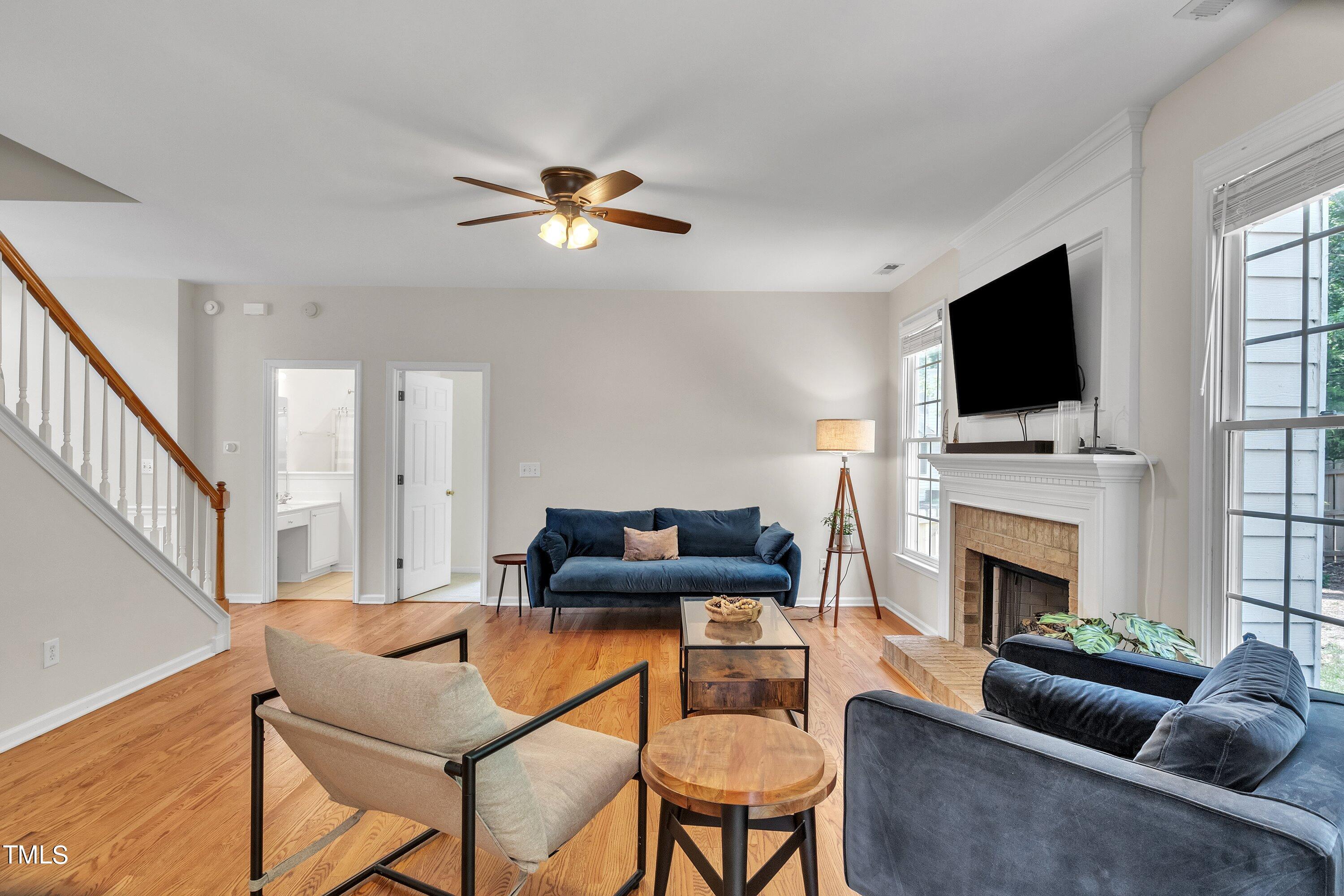 4702 Regency Drive Durham, NC 27713 - Photo 13 of 45 a living room with furniture a fireplace and a flat screen tv