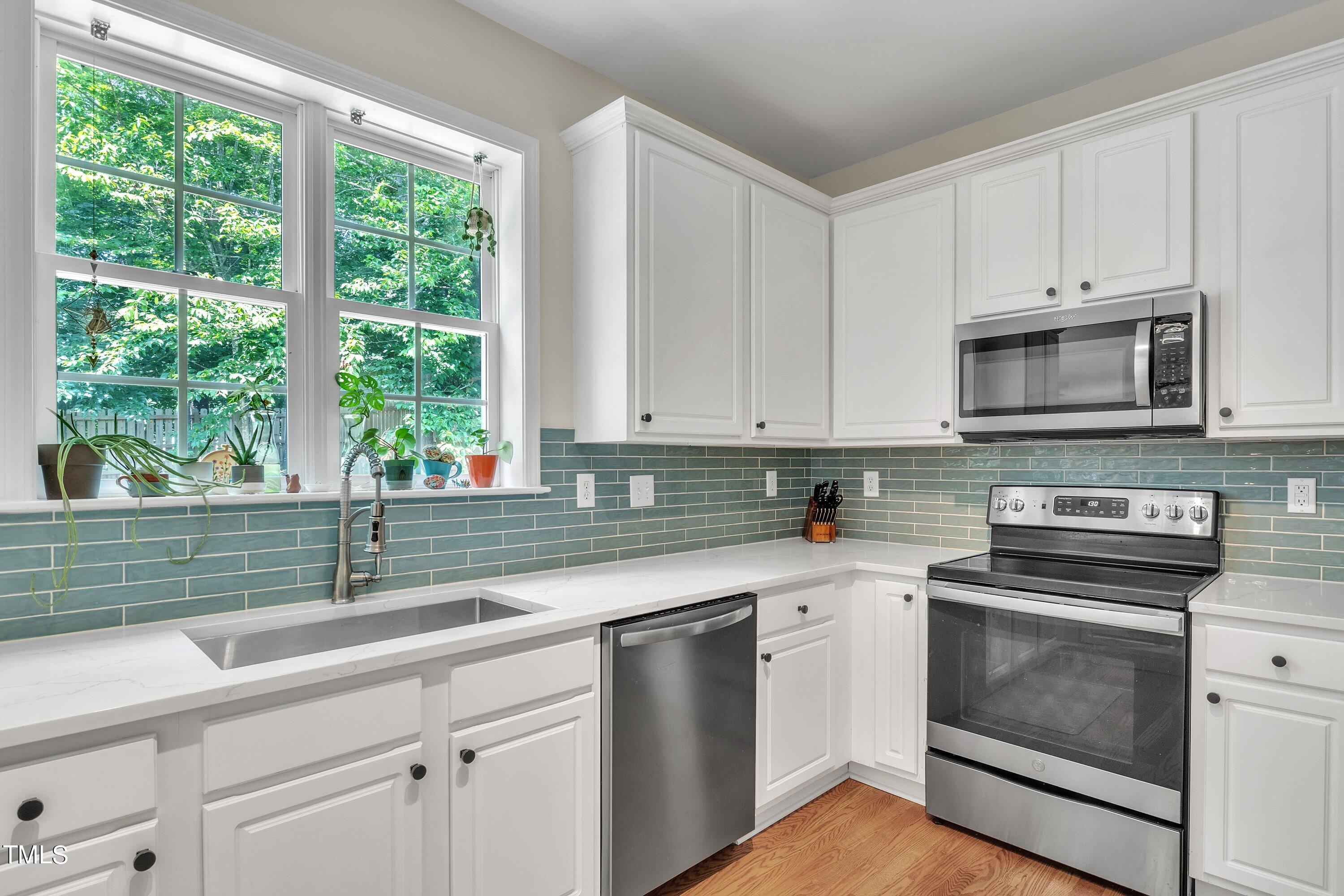 4702 Regency Drive Durham, NC 27713 - Photo 15 of 45 a kitchen with appliances a sink and a window