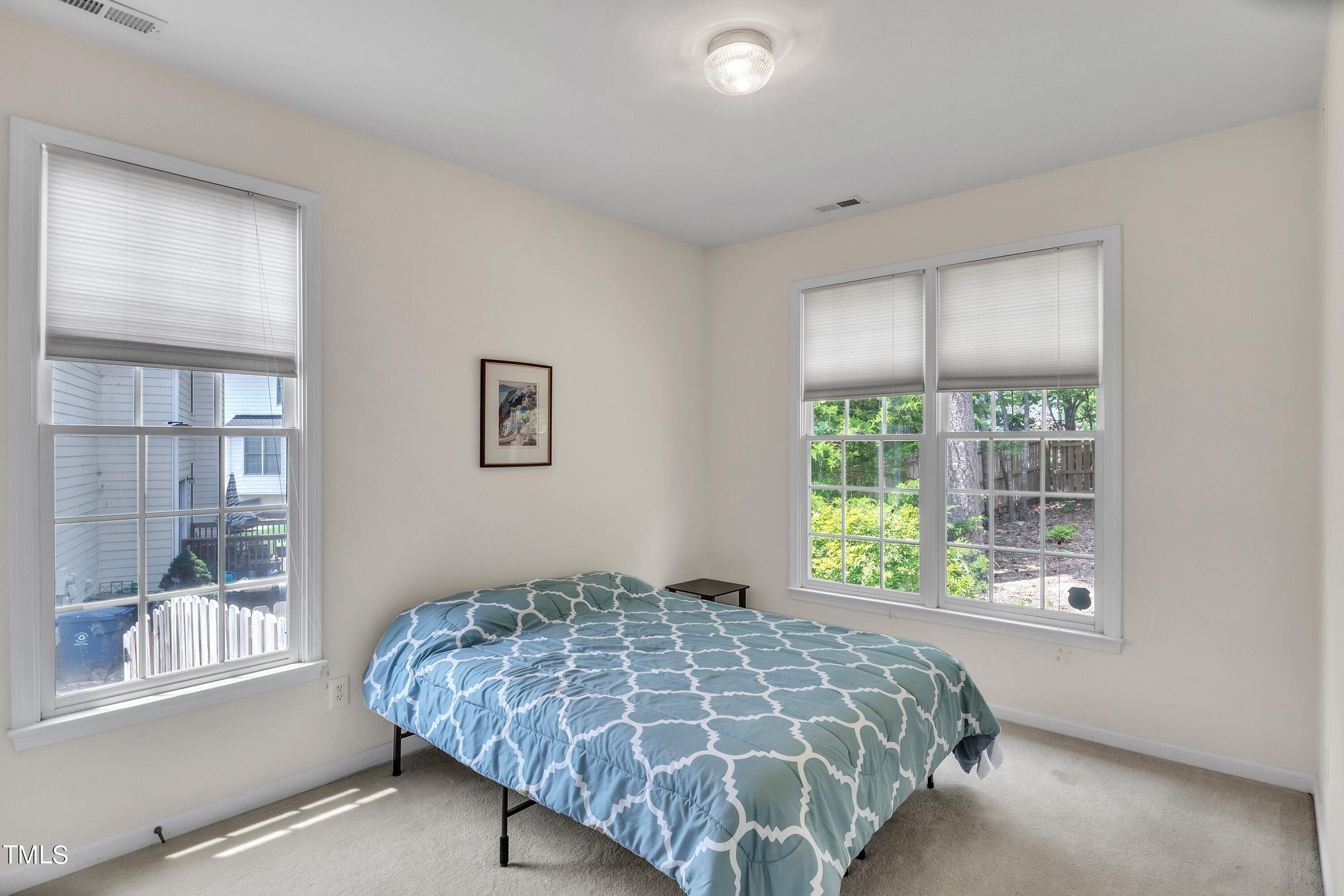 4702 Regency Drive Durham, NC 27713 - Photo 22 of 45 a bed sitting in a bedroom next to a window